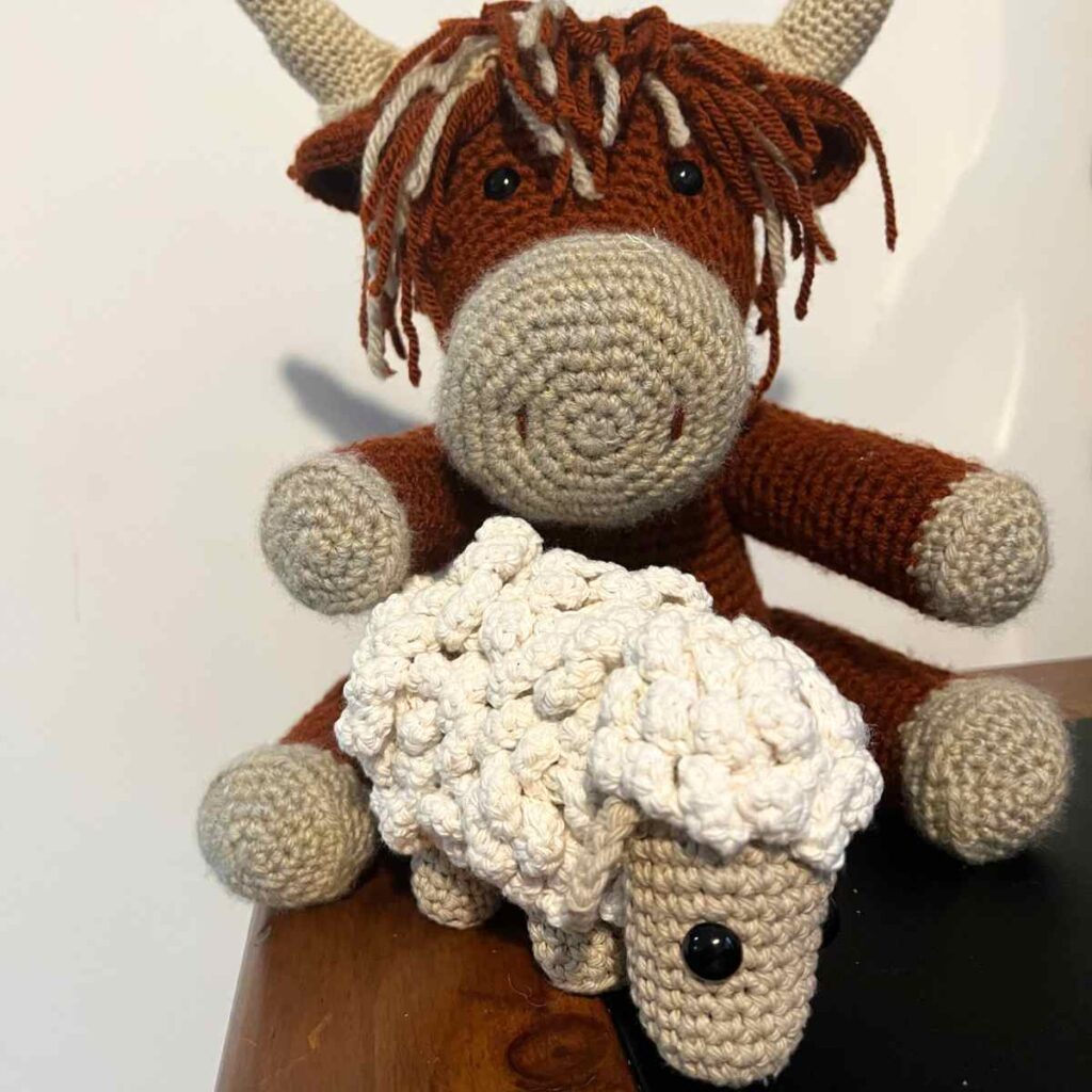 crochet highland cow and crocheted sheep