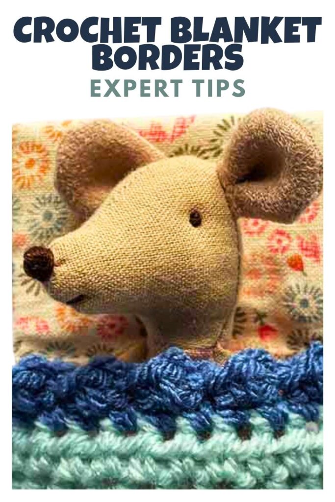 photo of a toy mouse tucked in with a crochet blanket