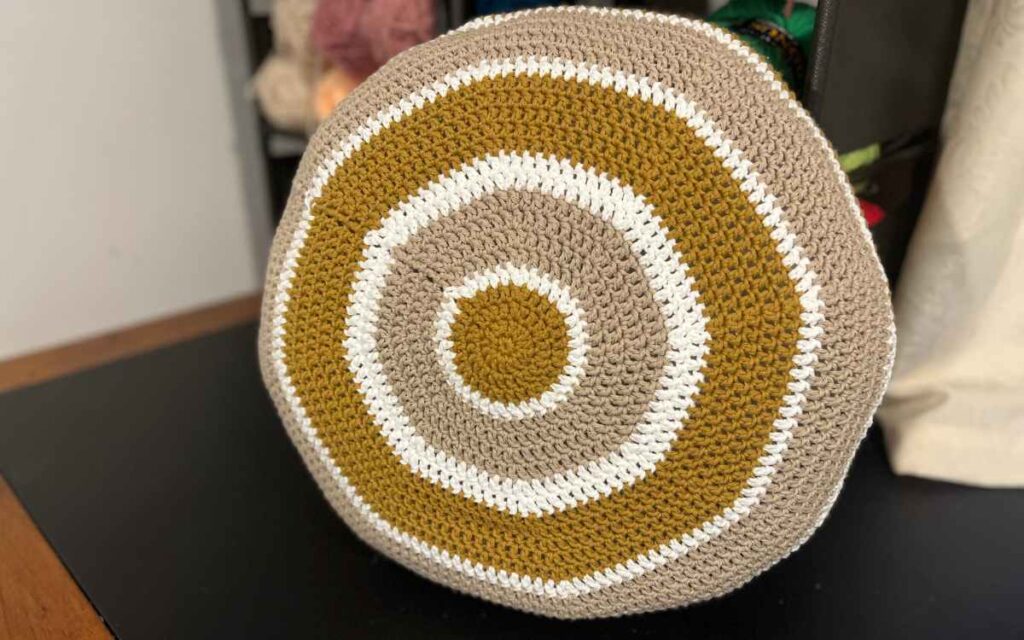 photograph of a round crochet throw pillow