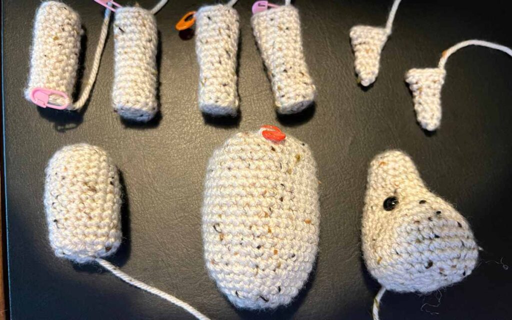 photo of the individual pieces of the crochet llama before they are sewn together