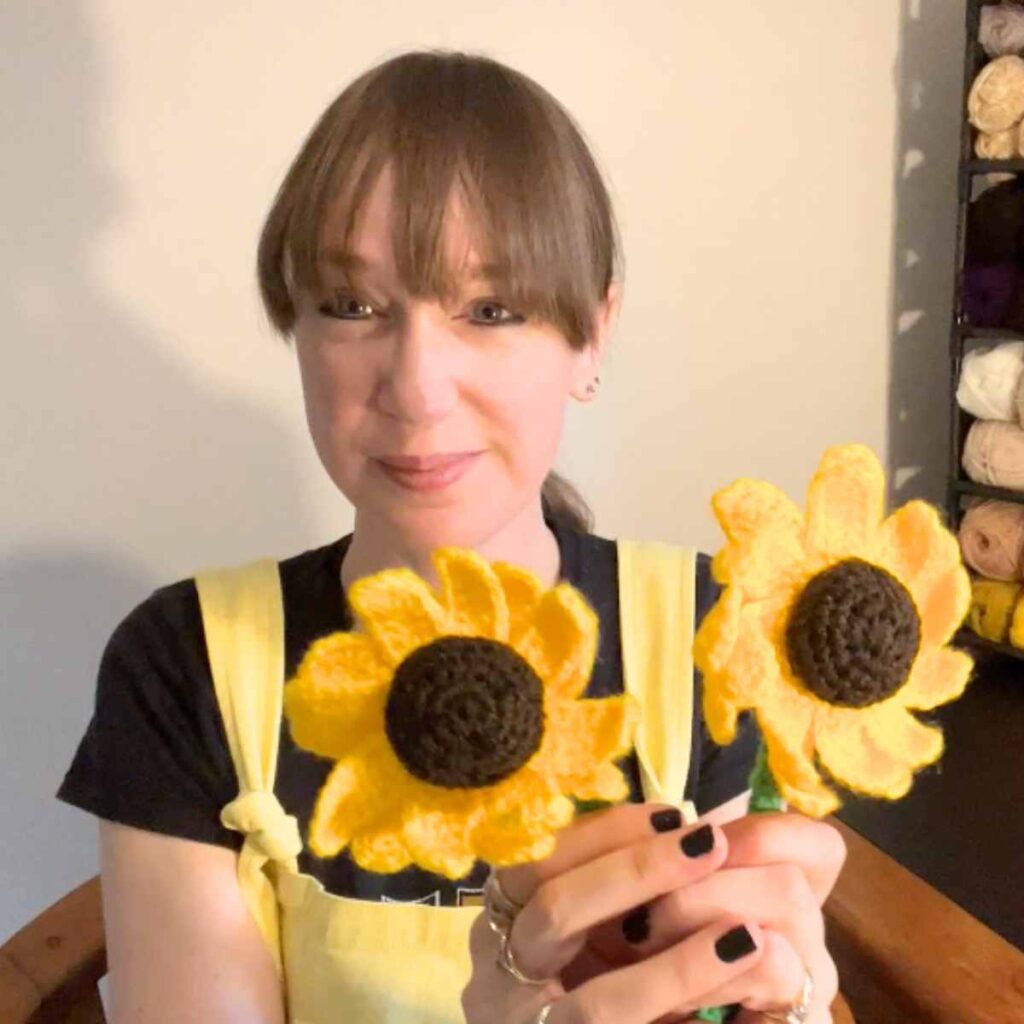 photo of lucy kate crochet holding her sunflower design