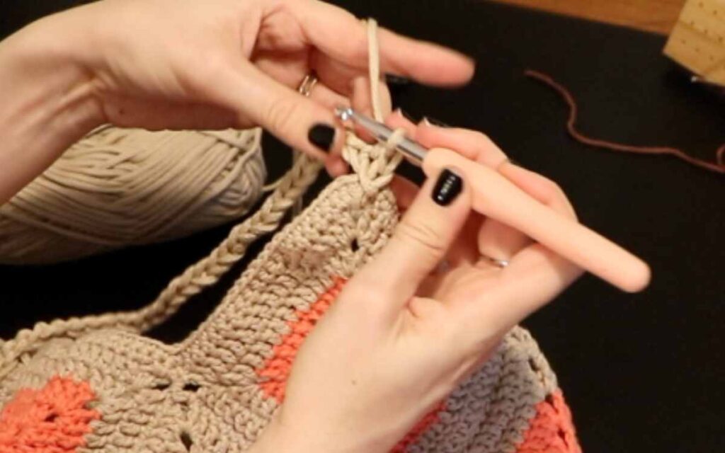 crocheting the granny square bag's strap