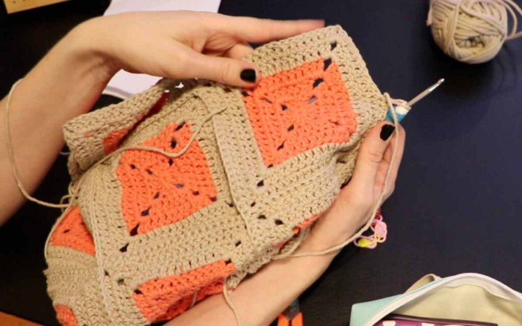 image showing how to single crochet two granny squares together