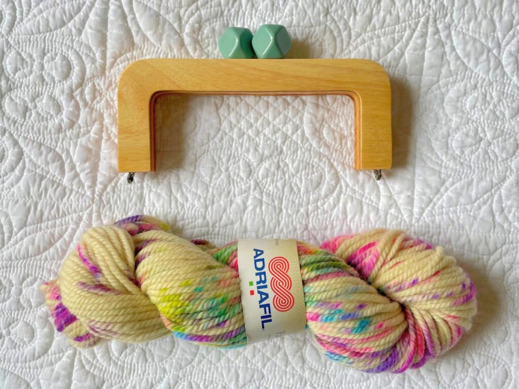 empty purse frame and yarn