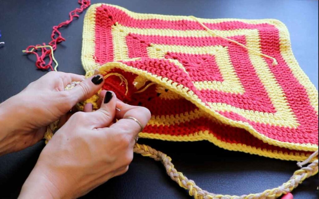 photo showing how to sew in the ends of the crochet bag strap