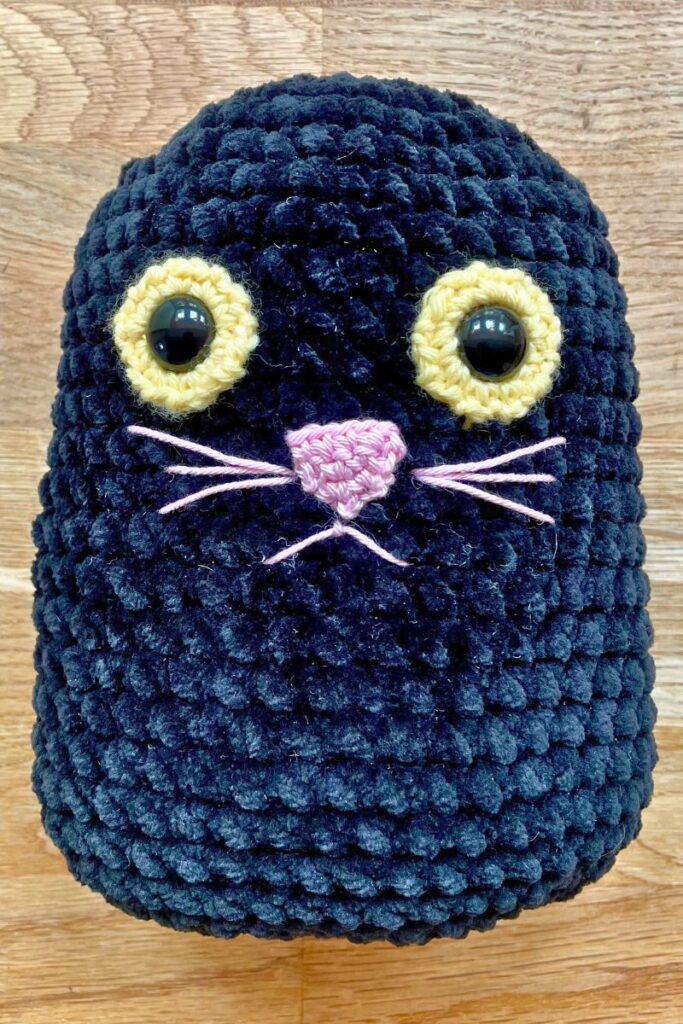 squishy crochet cat with just the ears left to add