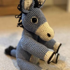 image of the crochet donkey sitting on the floor