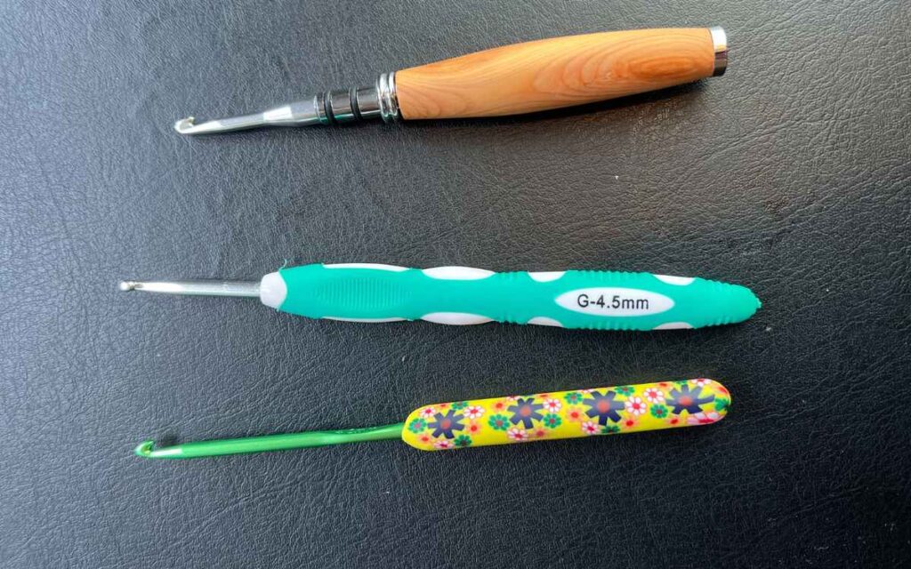 photo showing three crochet hooks with different ergonomic grips