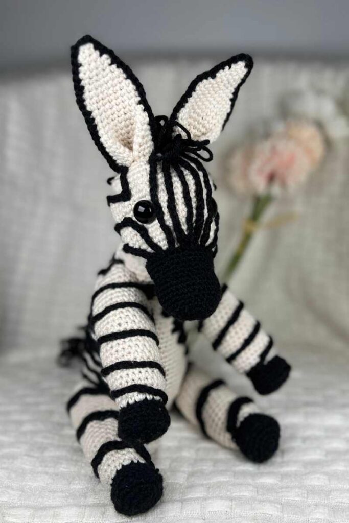 image of the crochet zebra on a blanket
