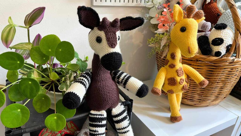 okapi and giraffe toys sitting together on my shelf
