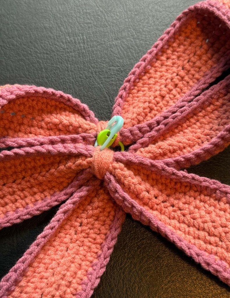 stitch markers holding the bow together