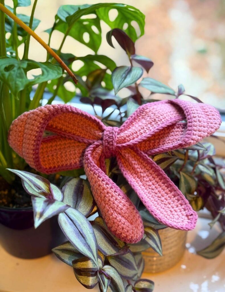 crochet bow displayed on a plant