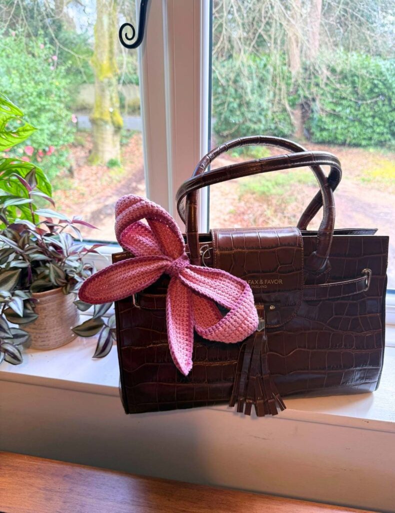 the crochet bow on the bag in the windowsill
