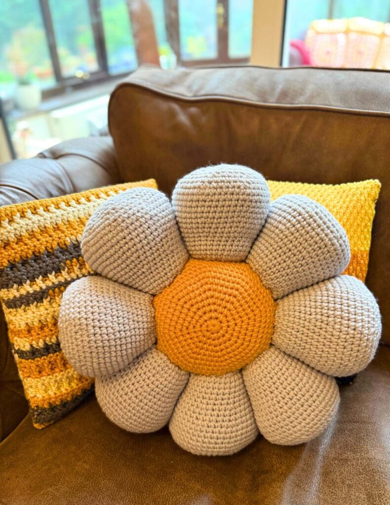 crochet flower pillow with other crochet pillows on my sofa