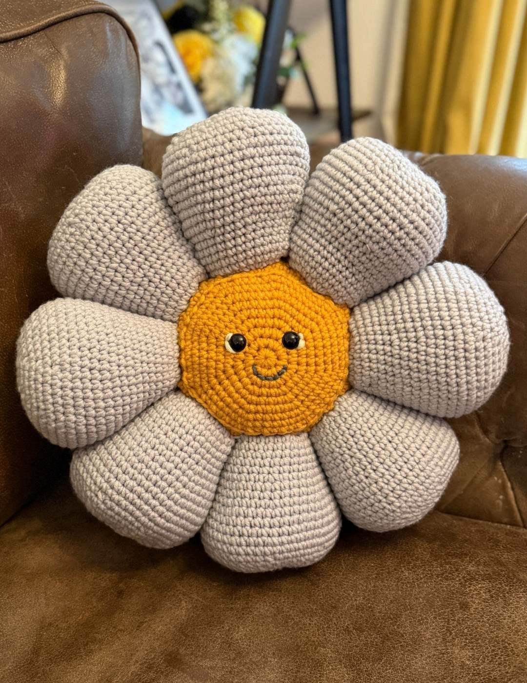 the crochet flower pillow sitting on my couch