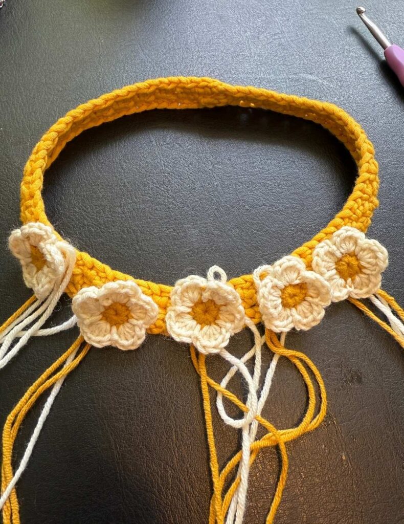 sewing the rest of the flowers onto the headband
