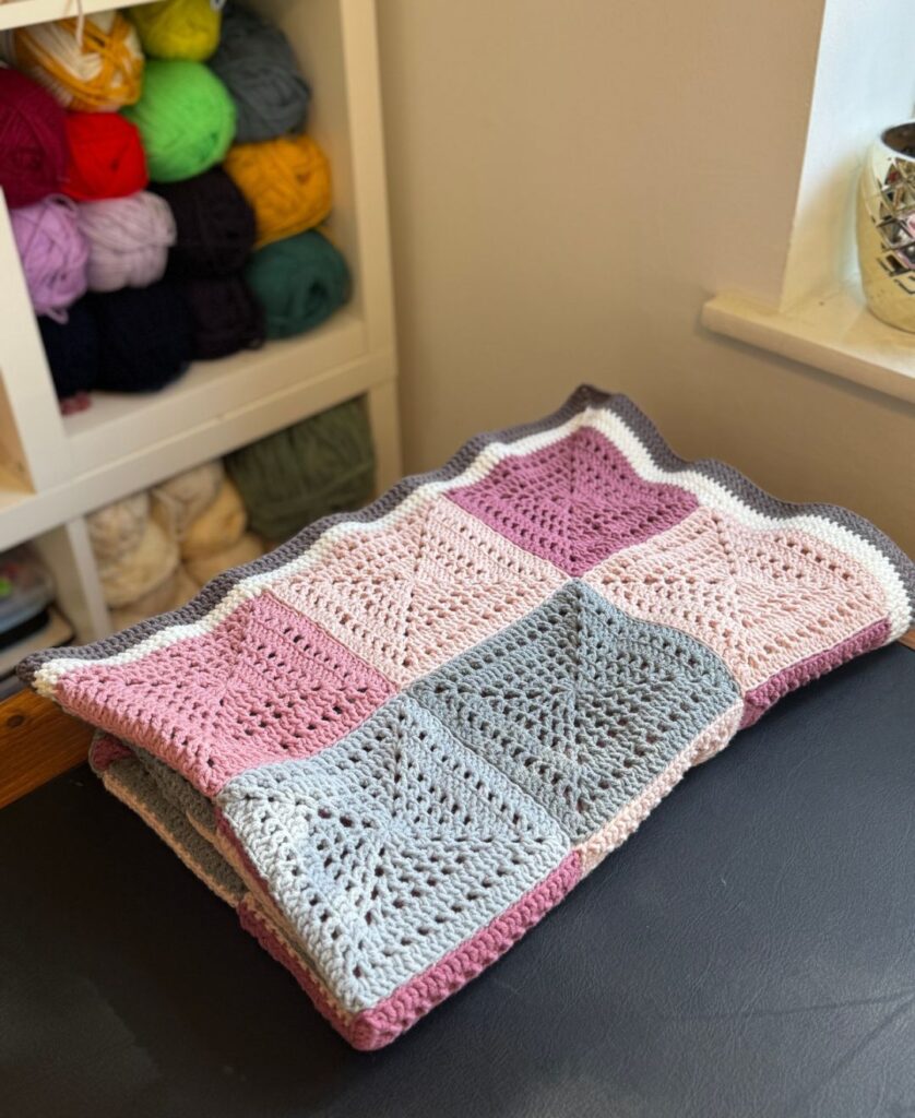 pink crochet blanket folded up