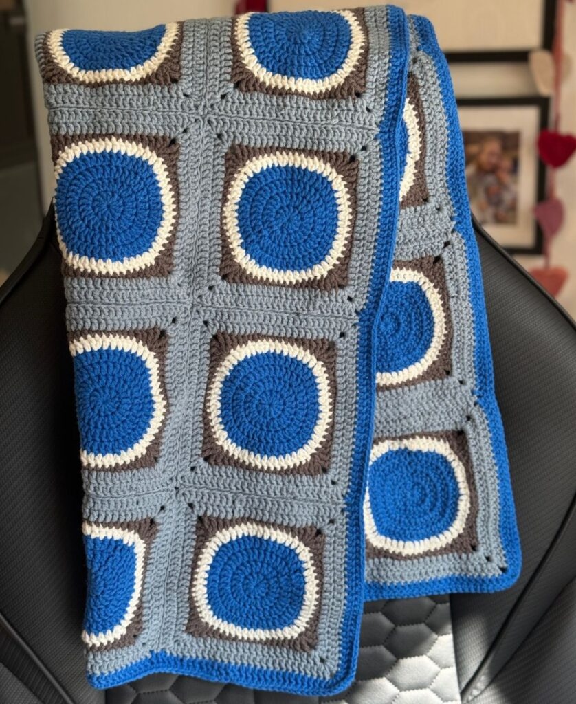 finished blue crochet blanket on my chair